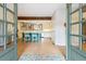 Bright kitchen features an island, stainless steel appliances, white cabinetry, and hardwood floors at 7317 Fremont Pl, Larkspur, CO 80118