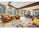Open-concept living and dining area with exposed beams and large windows at 7317 Fremont Pl, Larkspur, CO 80118