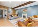 Inviting living room with wooden accent wall, fireplace, and colorful rug at 7317 Fremont Pl, Larkspur, CO 80118