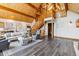 Bright open living room featuring wood beams, staircase and hardwood floors at 7317 Fremont Pl, Larkspur, CO 80118