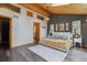 Comfortable main bedroom with wood plank ceiling, skylight, large windows, and stylish decor at 7317 Fremont Pl, Larkspur, CO 80118