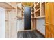 Walk-in closet with custom wood shelving and ample storage space at 7317 Fremont Pl, Larkspur, CO 80118
