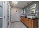 Bathroom featuring dual sinks, modern lighting, and light gray accents at 3251 Interlocken Dr, Evergreen, CO 80439