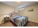 Bedroom featuring a metal bed frame, colorful bedding, and bedside table with a decorative lamp at 3251 Interlocken Dr, Evergreen, CO 80439