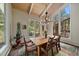 Bright dining area with large windows, wood floors, and a vaulted wood ceiling at 3251 Interlocken Dr, Evergreen, CO 80439