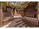 Inviting home entryway with wooden stairs and natural wood siding at 3251 Interlocken Dr, Evergreen, CO 80439