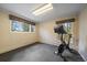 Bright exercise room with black mat flooring, two windows, and an exercise bike at 3251 Interlocken Dr, Evergreen, CO 80439