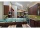 Modern kitchen features island seating, stainless steel appliances, and skylights at 3251 Interlocken Dr, Evergreen, CO 80439