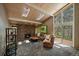 Cozy living room with stone fireplace, skylights, and walls of windows at 3251 Interlocken Dr, Evergreen, CO 80439