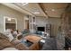 Spacious living room features a stone fireplace, skylights and modern furnishings at 3251 Interlocken Dr, Evergreen, CO 80439