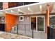 Outdoor balcony featuring metal railings, an air conditioning unit, and a view into the building's interior at 1495 Vrain St # 115, Denver, CO 80204