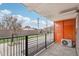 Outdoor balcony with metal railings, a view of the neighborhood, and an air conditioning unit at 1495 Vrain St # 115, Denver, CO 80204