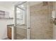 Modern bathroom featuring glass-enclosed shower, tiled walls, and contemporary fixtures at 1495 Vrain St # 115, Denver, CO 80204