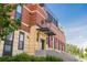 Brick building exterior featuring Odell Brewing Co. signage, a covered entrance, and manicured landscaping at 1495 Vrain St # 115, Denver, CO 80204