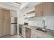 Well-lit kitchen featuring modern stainless steel appliances and natural wood cabinetry at 1495 Vrain St # 115, Denver, CO 80204