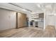 Spacious living area with a Murphy bed, wood floors, and adjacent kitchen area with stainless steel appliances at 1495 Vrain St # 115, Denver, CO 80204
