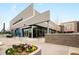Starbucks Coffee storefront with modern architecture, large windows, outdoor seating and landscaped flower bed at 1495 Vrain St # 115, Denver, CO 80204