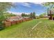 A spacious backyard with lush green grass and a wooden fence, offering privacy and a serene outdoor setting at 5861 S Orleans Way, Centennial, CO 80015