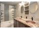 Modern bathroom with dual vanity, granite countertops, decorative mirrors, and stylish tiled shower at 5861 S Orleans Way, Centennial, CO 80015