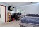 Comfortable bedroom featuring a desk, window, and dark grey bedspread at 5861 S Orleans Way, Centennial, CO 80015