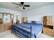Bright bedroom featuring a ceiling fan and a walk-in closet for ample storage at 5861 S Orleans Way, Centennial, CO 80015