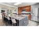 Spacious kitchen featuring a large granite island with seating and modern stainless steel appliances at 5861 S Orleans Way, Centennial, CO 80015
