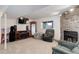 Finished basement living room with a cozy stone fireplace and entertainment area at 5861 S Orleans Way, Centennial, CO 80015