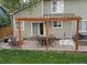 Backyard patio features a pergola, an outdoor dining area, and a separate seating space at 5256 E 129Th Pl, Thornton, CO 80241