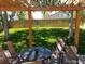 Backyard patio covered by a wooden pergola offers shade and a pleasant view of the yard at 5256 E 129Th Pl, Thornton, CO 80241