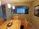 A formal dining room with light wood chairs, a matching table, and stylish pendant lighting at 5256 E 129Th Pl, Thornton, CO 80241
