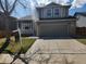 Two-story home featuring a two-car garage, covered porch, and well-maintained landscaping at 5256 E 129Th Pl, Thornton, CO 80241