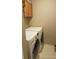 Well-equipped laundry room with modern, front-loading washer and dryer, plus a cabinet for extra storage at 5256 E 129Th Pl, Thornton, CO 80241