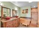 This bathroom features vessel sinks, a wooden soaking tub, and a walk-in shower at 9648 Yegge Rd, Morrison, CO 80465