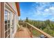 This covered deck offers a seating area with beautiful views of the surrounding landscape at 9648 Yegge Rd, Morrison, CO 80465