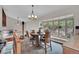The dining room has a bay window, decorative lighting, wood table, and stairs to the upper level at 9648 Yegge Rd, Morrison, CO 80465