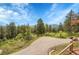 Scenic view from a driveway overlooking mountains and trees at 9648 Yegge Rd, Morrison, CO 80465
