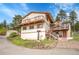 Two-story home with a balcony and outdoor patio with beautiful steps leading to the property at 9648 Yegge Rd, Morrison, CO 80465