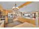 The kitchen has light wood cabinets, tile floors, breakfast bar, an island, and stainless refrigerator at 9648 Yegge Rd, Morrison, CO 80465