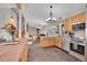 An open-concept kitchen has tile floors, stainless appliances, and breakfast bar with stairs to the main living area at 9648 Yegge Rd, Morrison, CO 80465
