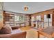 The living room has wood paneled walls, a large window, and hardwood floors at 9648 Yegge Rd, Morrison, CO 80465