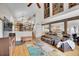 Open concept living room with vaulted ceilings, exposed beams, and comfortable seating at 9648 Yegge Rd, Morrison, CO 80465