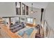 Open concept living room with vaulted ceilings, exposed beams, and upper loft book shelves at 9648 Yegge Rd, Morrison, CO 80465