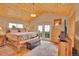This main bedroom has a wood plank ceiling, an upholstered bench, and French doors with views of the outdoors at 9648 Yegge Rd, Morrison, CO 80465