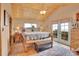 This main bedroom features a wood plank ceiling, an upholstered bench, and French doors with outdoor views at 9648 Yegge Rd, Morrison, CO 80465
