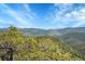 Expansive mountain view showcasing rolling hills and lush greenery at 9648 Yegge Rd, Morrison, CO 80465