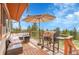 Cozy outdoor deck with seating, umbrella, and grill, perfect for entertaining at 9648 Yegge Rd, Morrison, CO 80465