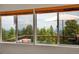Beautiful view from the home, showcasing the deck and surrounding trees at 9648 Yegge Rd, Morrison, CO 80465
