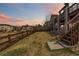 Large backyard featuring a wood fence and stairs leading to the deck above at 6743 Serena Ave, Castle Pines, CO 80108