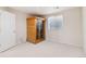 Carpeted bedroom featuring a wooden sauna, window and a white painted door at 6743 Serena Ave, Castle Pines, CO 80108