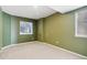 Room with sage green walls, carpet, and window for natural light at 6743 Serena Ave, Castle Pines, CO 80108